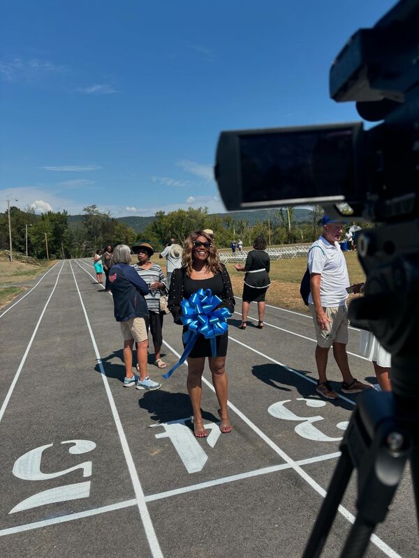 A ribbon-cutting bow held on lane four of the newly resurfaced track