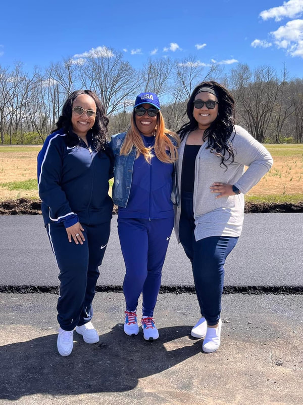 Sharrieffa Barksdale and two supporters walking the freshly paved track