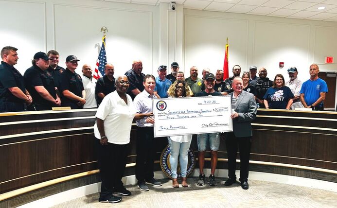 City of Harriman officials presenting a $5,000 check for track renovation